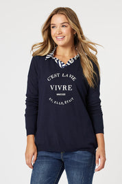A model wearing the Cest La Vie Knit in colour Navy (Blue), from the front, cropped image