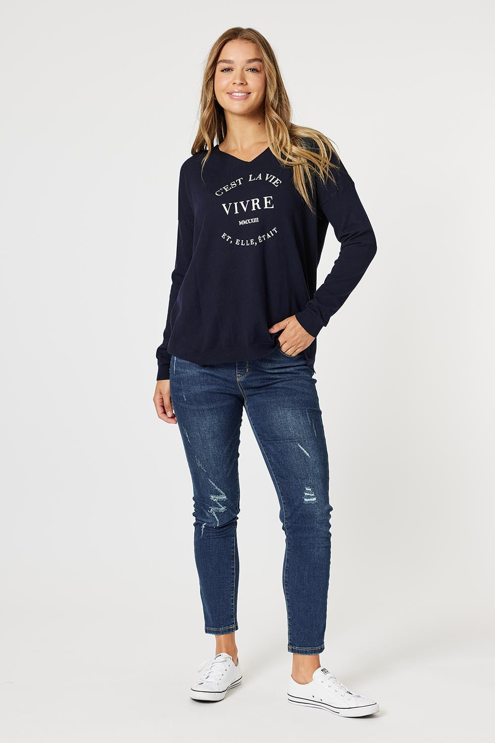 A model wearing the Cest La Vie Knit in colour Navy (Blue), from the front, showing the whole outfit