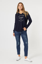 A model wearing the Cest La Vie Knit in colour Navy (Blue), from the front, showing the whole outfit