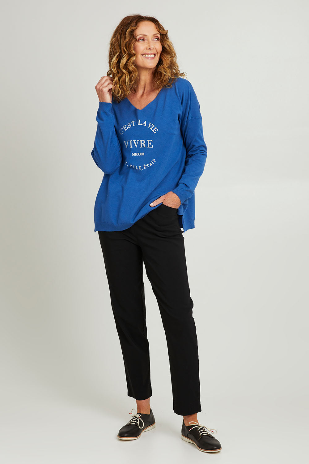 Model Emma wearing size S of the Cest La Vie Knit in colour Sapphire (Blue), from the front, showing the whole outfit