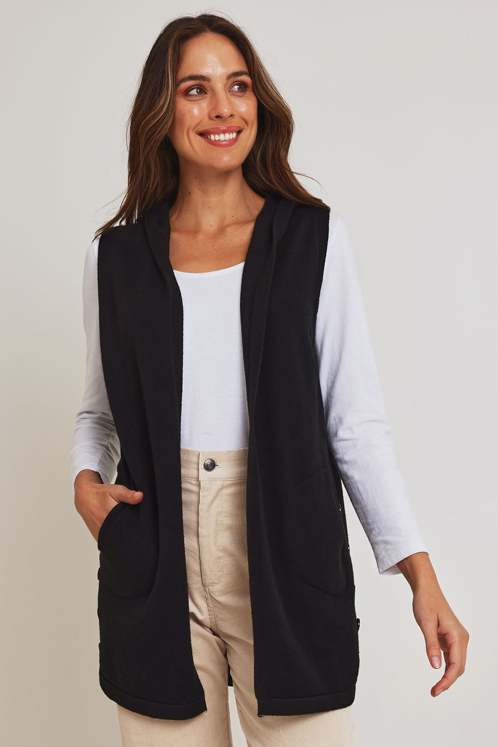 Model Madeline wearing size S of the Ollie Side Button Knit Vest in colour Black (Black), from the front, cropped image