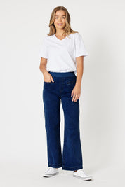 A model wearing the Maddy Wide Leg Jean in colour Darkdenim (Blue), from the front, showing the whole outfit