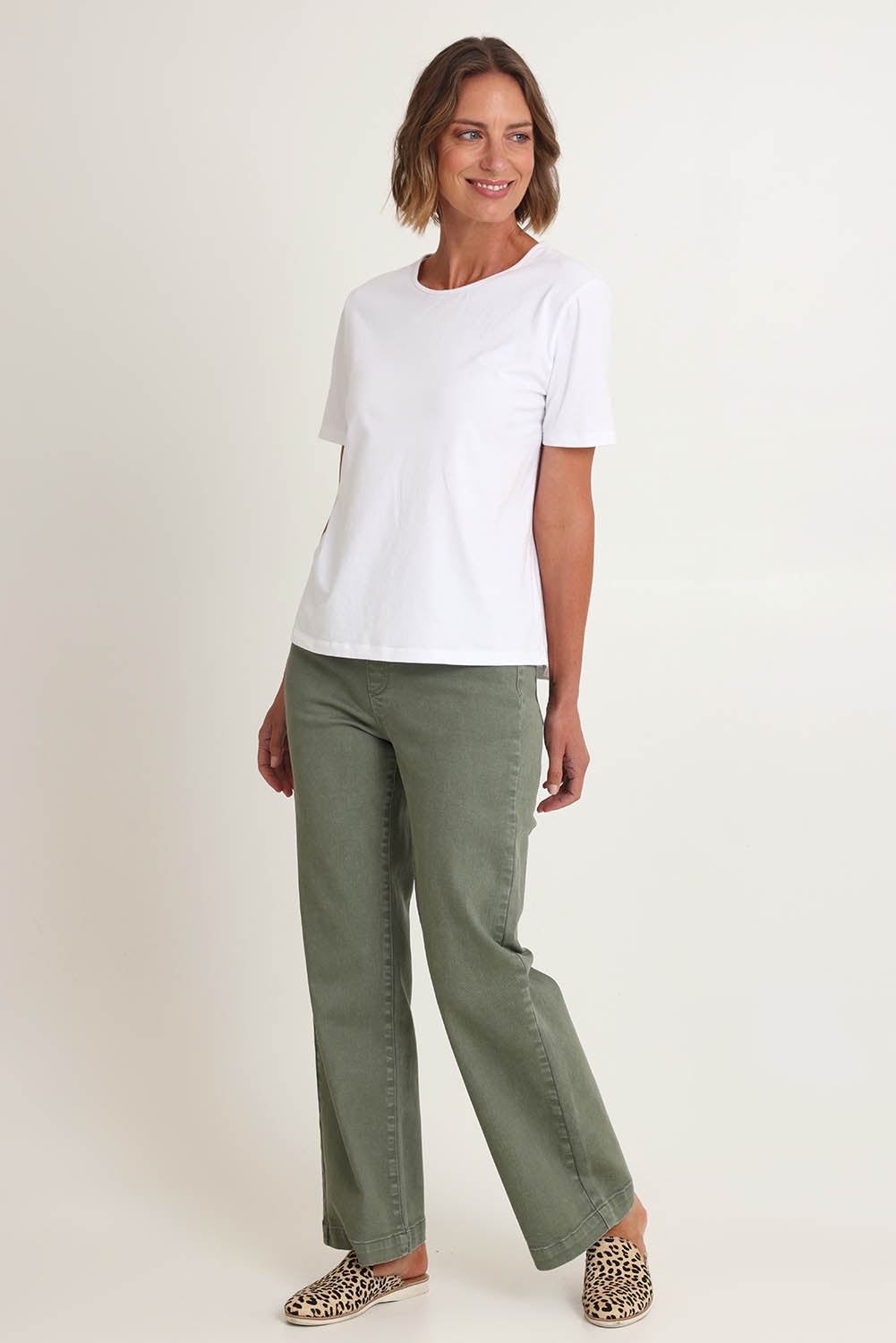 Model Riina wearing size S of the Maddy Wide Leg Jean in colour Khaki (Green), from the front, showing the whole outfit