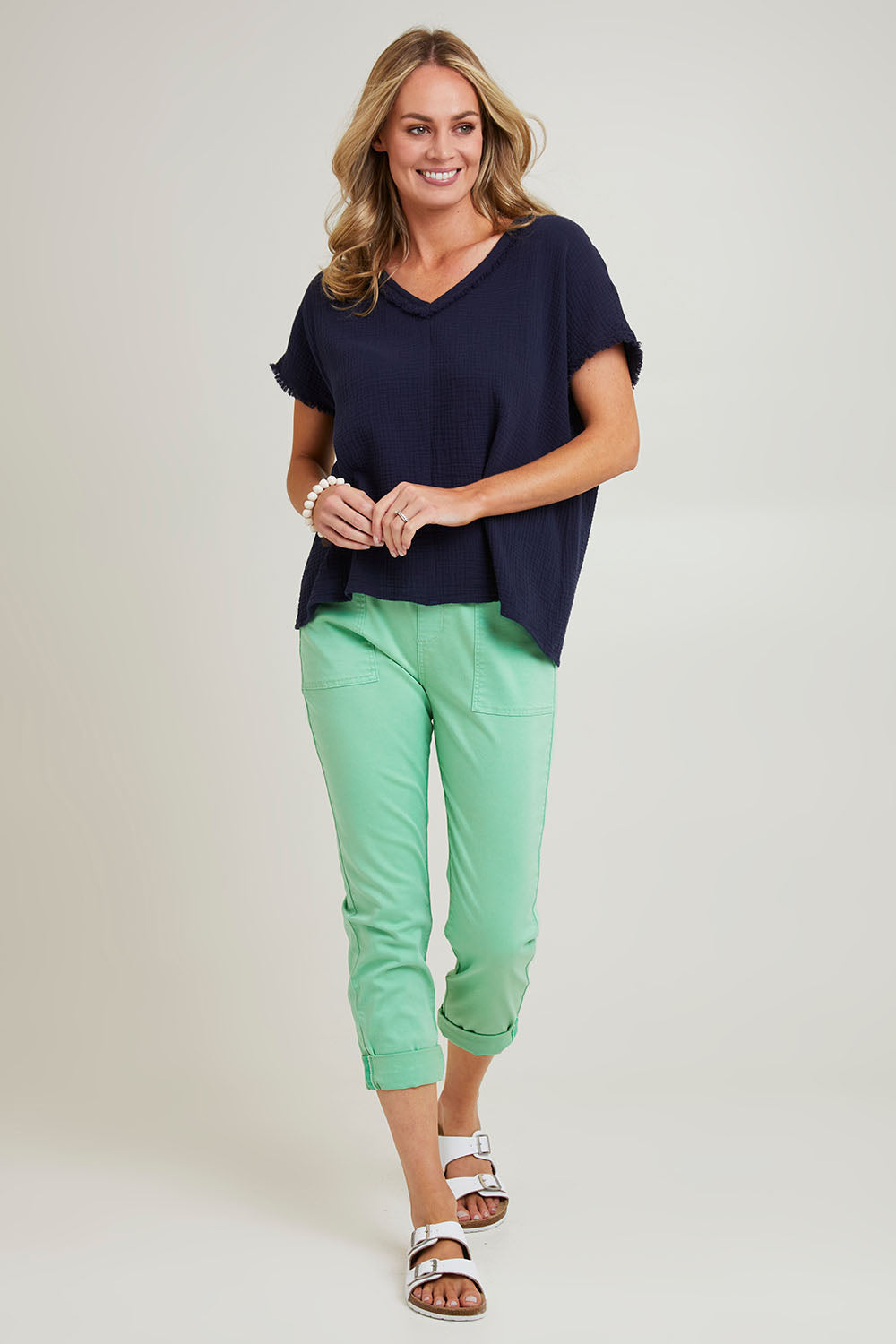 Model Grace wearing size S of the Isabella Cotton Pant in colour Green (Green), from the front, showing the whole outfit