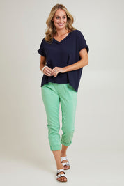 Model Grace wearing size S of the Isabella Cotton Pant in colour Green (Green), from the front, showing the whole outfit