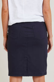 Model Grace wearing size S of the Portia Denim Skirt in colour Navy (Blue), from the back