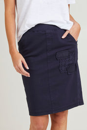 Model Grace wearing size S of the Portia Denim Skirt in colour Navy (Blue), from the front, cropped image