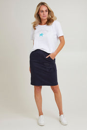 Model Grace wearing size S of the Portia Denim Skirt in colour Navy (Blue), from the front, showing the whole outfit