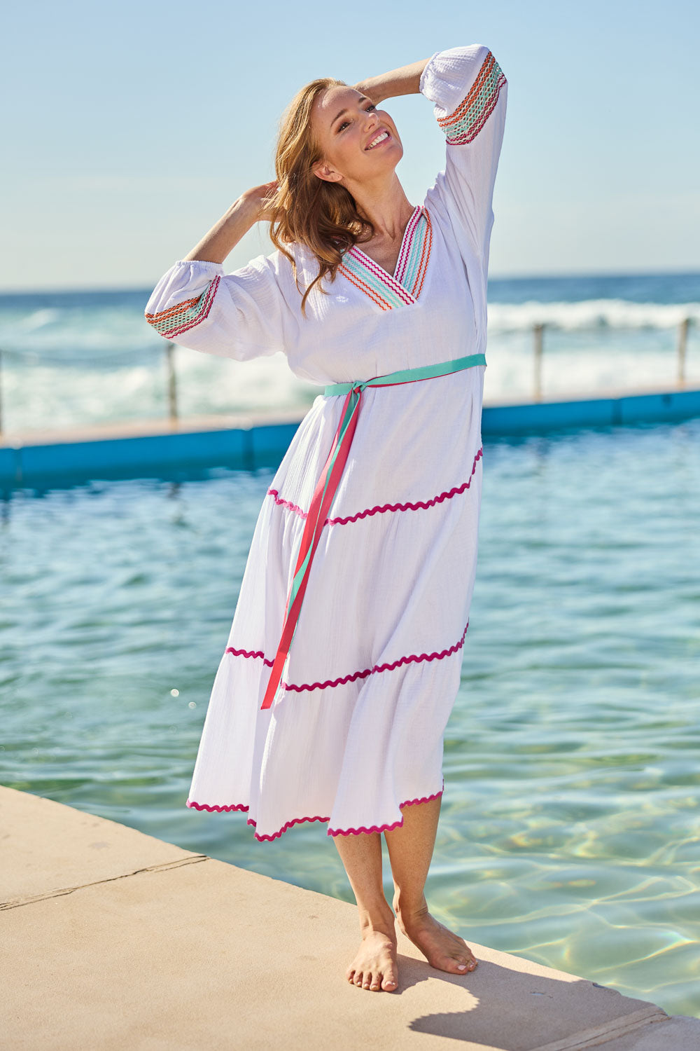 Model Katie wearing size S of the Byron Ciao Cotton Dress in colour White (White), from the front, showing the whole outfit