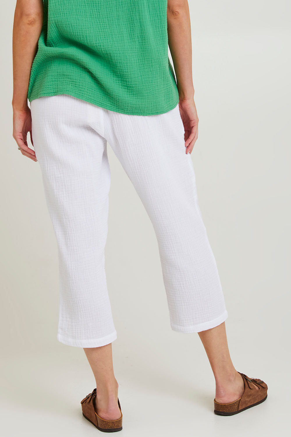 Model Grace wearing size S of the Byron Cotton 7/8 Pant in colour White (White), from the back