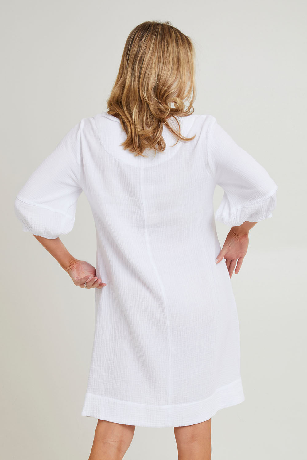 Model Grace wearing size S of the Byron Cotton Dress in colour White (White), from the back