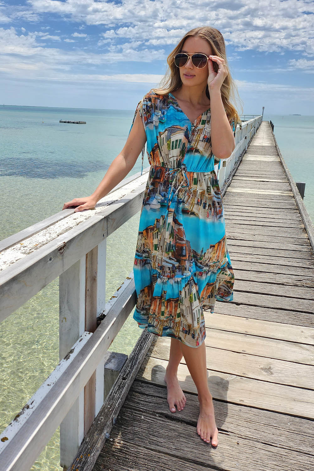A model wearing the Venice Cotton Dress in colour Blue (Blue), from the front, showing the whole outfit