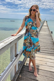 A model wearing the Venice Cotton Dress in colour Blue (Blue), from the front, showing the whole outfit