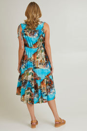 Model Grace wearing size S of the Venice Cotton Dress in colour Blue (Blue), from the back