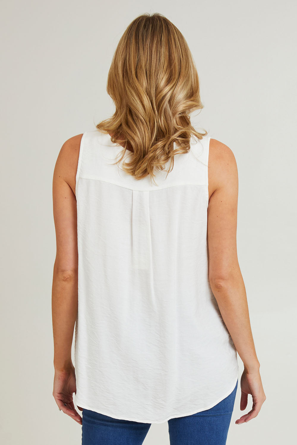 Model Grace wearing size S of the Vacation Cami in colour Ivory (White), from the back