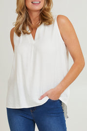 Model Grace wearing size S of the Vacation Cami in colour Ivory (White), from the front, cropped image