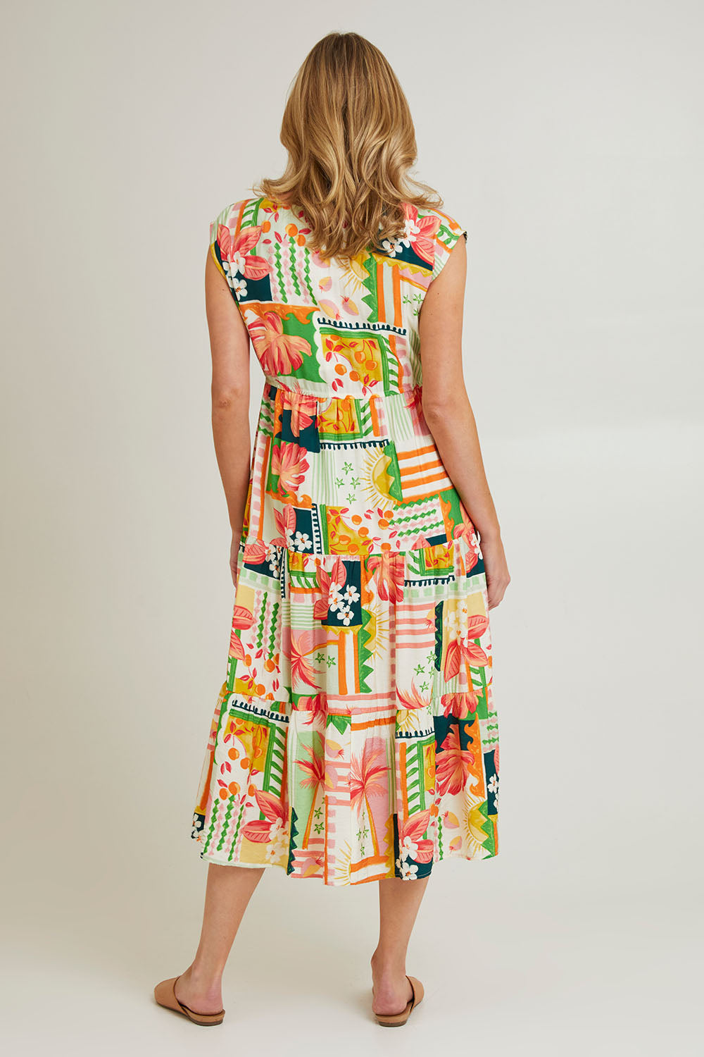Model Grace wearing size S of the Cancun Dress in colour Multi (Green), from the back