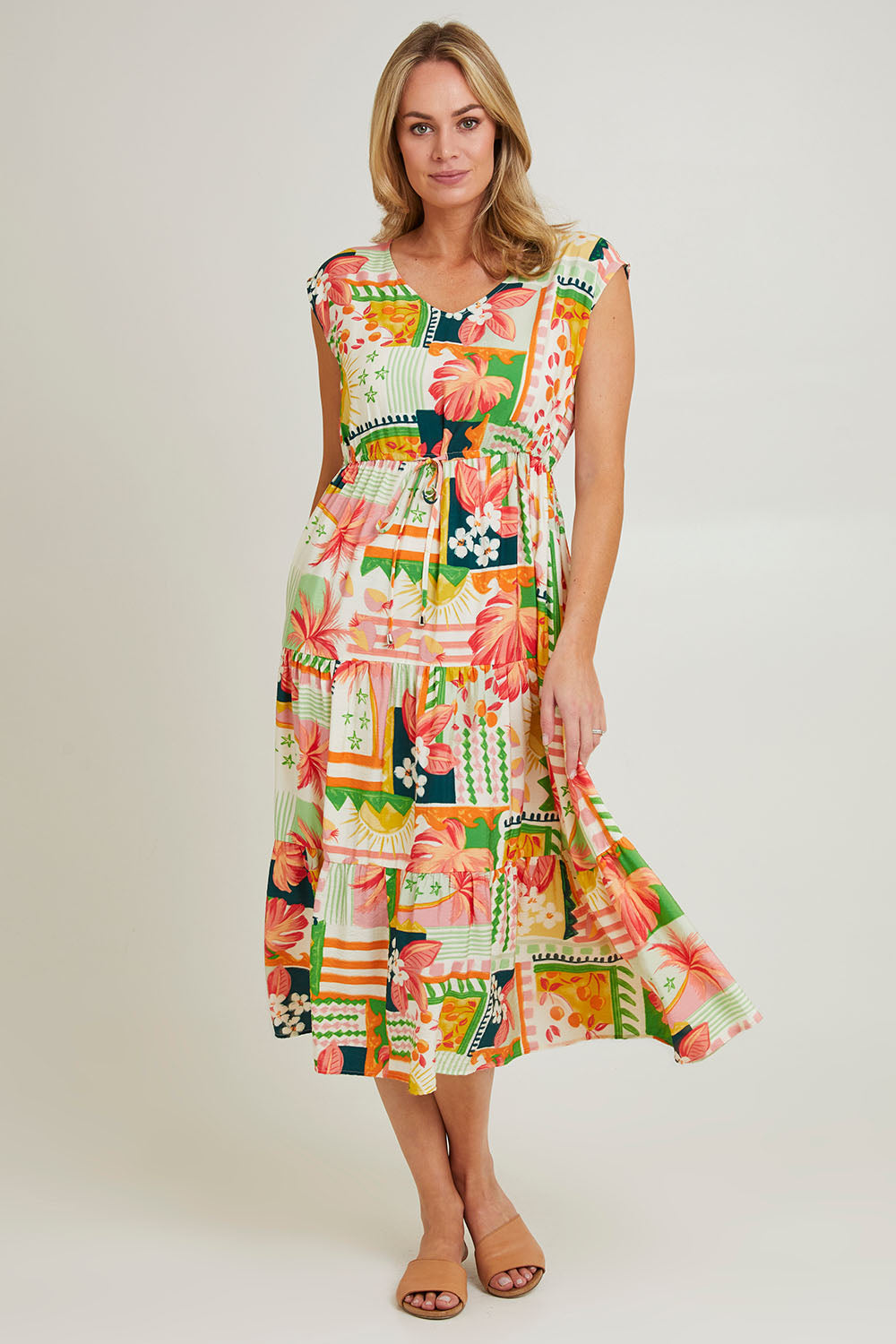 Model Grace wearing size S of the Cancun Dress in colour Multi (Green), from the front, showing the whole outfit