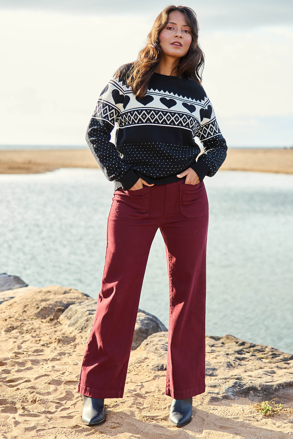 Model Tahnee wearing size S of the Carpenter Wide Leg Jean in colour Shiraz (Red), from the front, showing the whole outfit