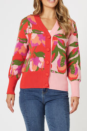 A model wearing the Bloom Cardigan in colour Pinkmulti (Pink), from the front, cropped image