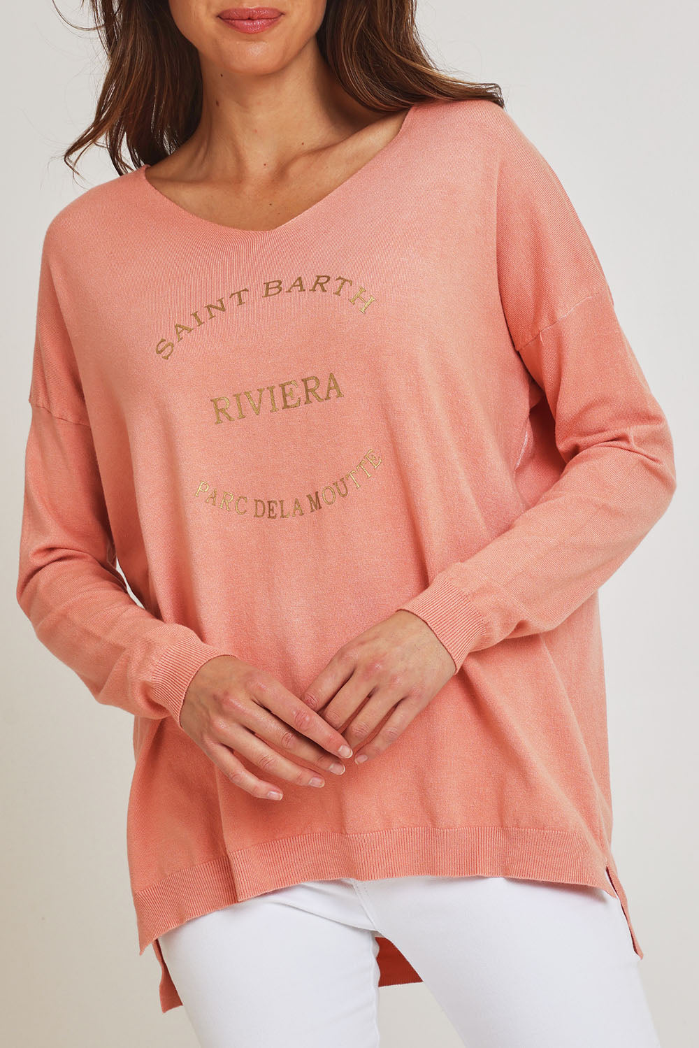 Model Madeline wearing size S of the Saint Barth Knit in colour Coral (Pink), from the front, cropped image