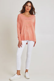 Model Madeline wearing size S of the Saint Barth Knit in colour Coral (Pink), from the front, showing the whole outfit