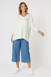 A model wearing the La Paris Knit Jumper in colour White (White), from the front, showing the whole outfit