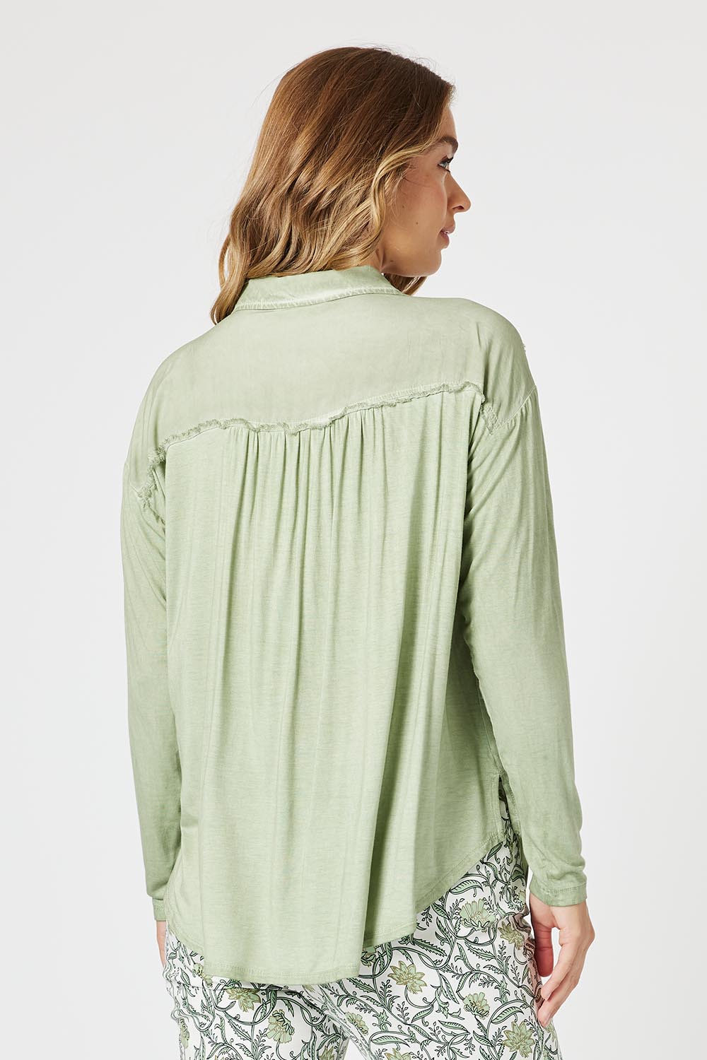 A model wearing the Paige Garment Washed Shirt in colour Washgreen (Green), from the back