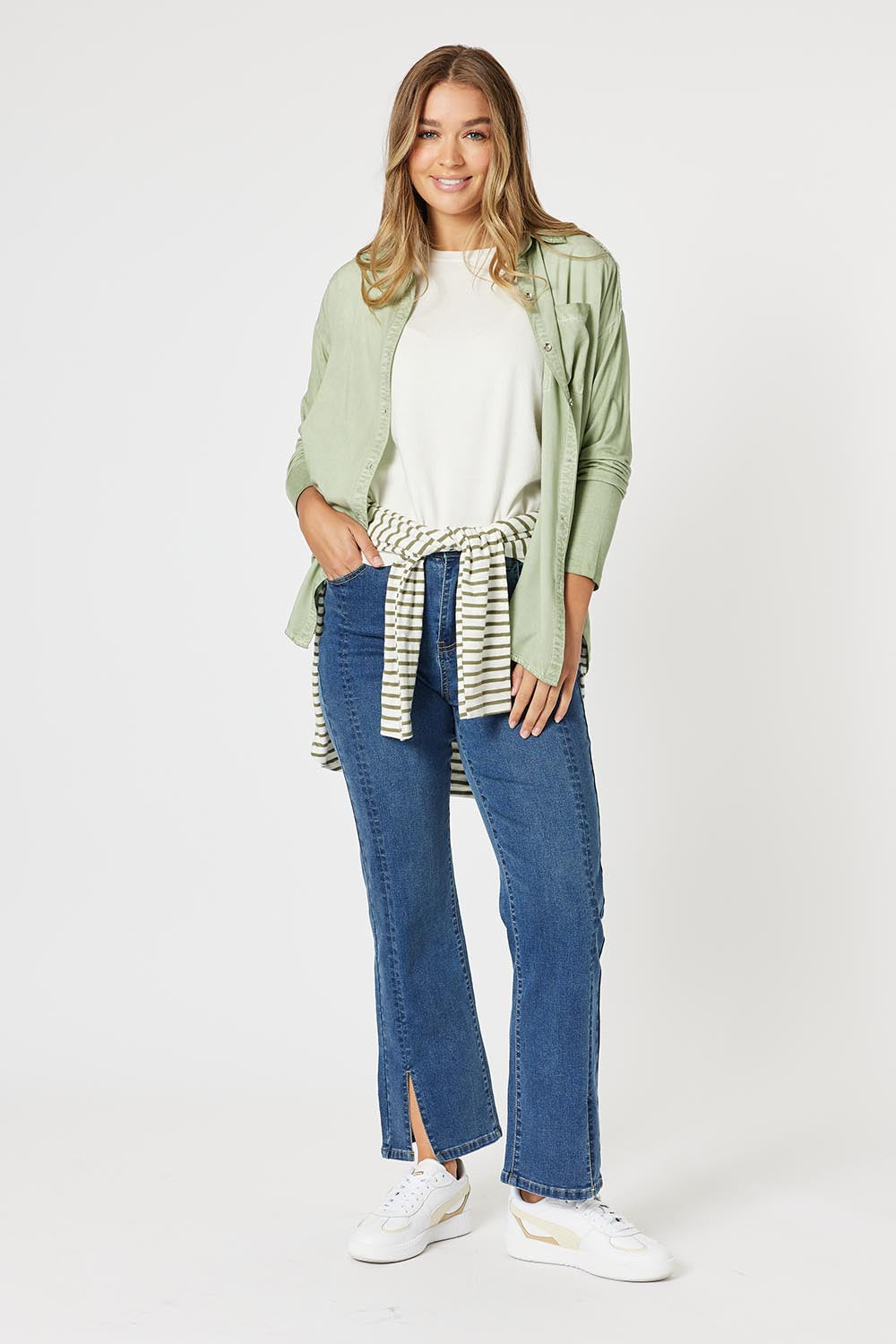 A model wearing the Paige Garment Washed Shirt in colour Washgreen (Green), from the front, showing the whole outfit