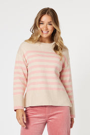 A model wearing the Tempo Knit Jumper in colour Blush (Pink), from the front, cropped image