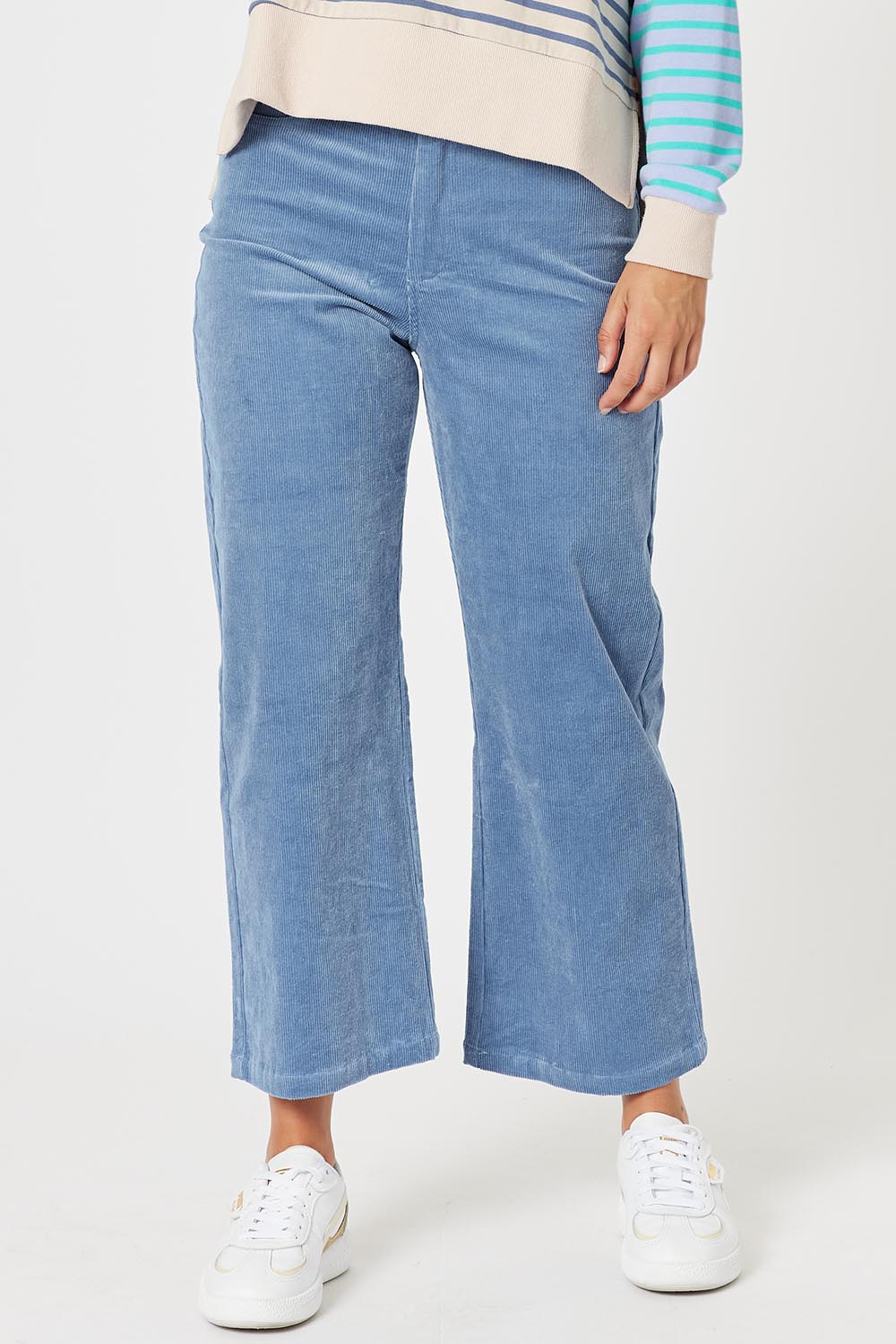 A model wearing the Lucy Stretch Cord Pant in colour Blue (Blue), from the front, cropped image