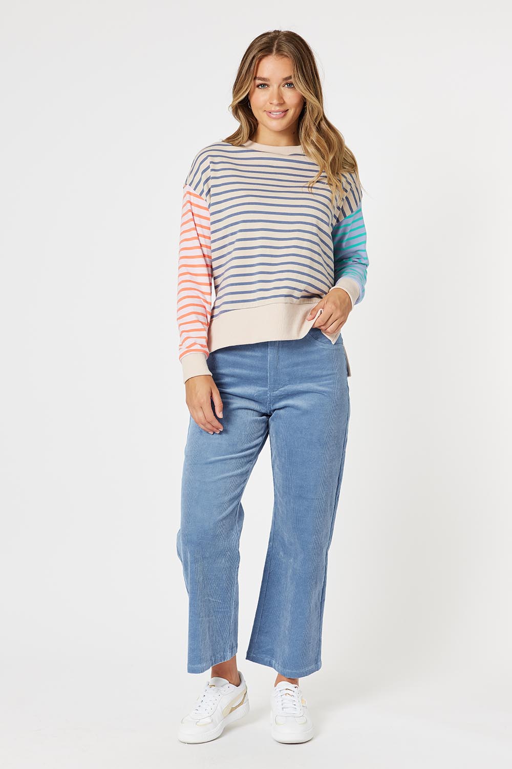 A model wearing the Lucy Stretch Cord Pant in colour Blue (Blue), from the front, showing the whole outfit