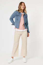 A model wearing the Lucy Stretch Cord Pant in colour Natural, from the front, showing the whole outfit