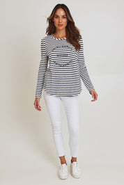 Model Madeline wearing size S of the Riviera Cotton Blend Tee in colour Navywhite (Blue), from the front, showing the whole outfit