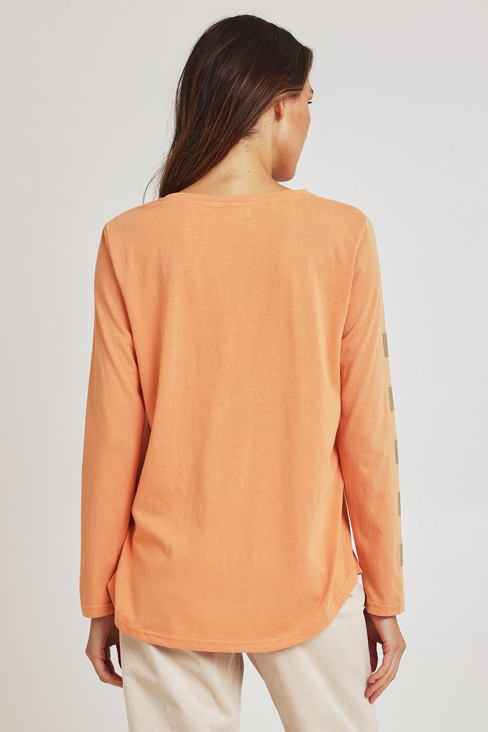 Model Madeline wearing size S of the Be Square Cotton Blend Tee in colour Melon, from the back