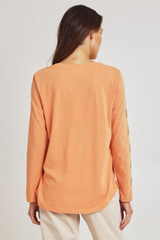 Model Madeline wearing size S of the Be Square Cotton Blend Tee in colour Melon, from the back