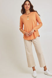 Model Madeline wearing size S of the Be Square Cotton Blend Tee in colour Melon, from the front, showing the whole outfit