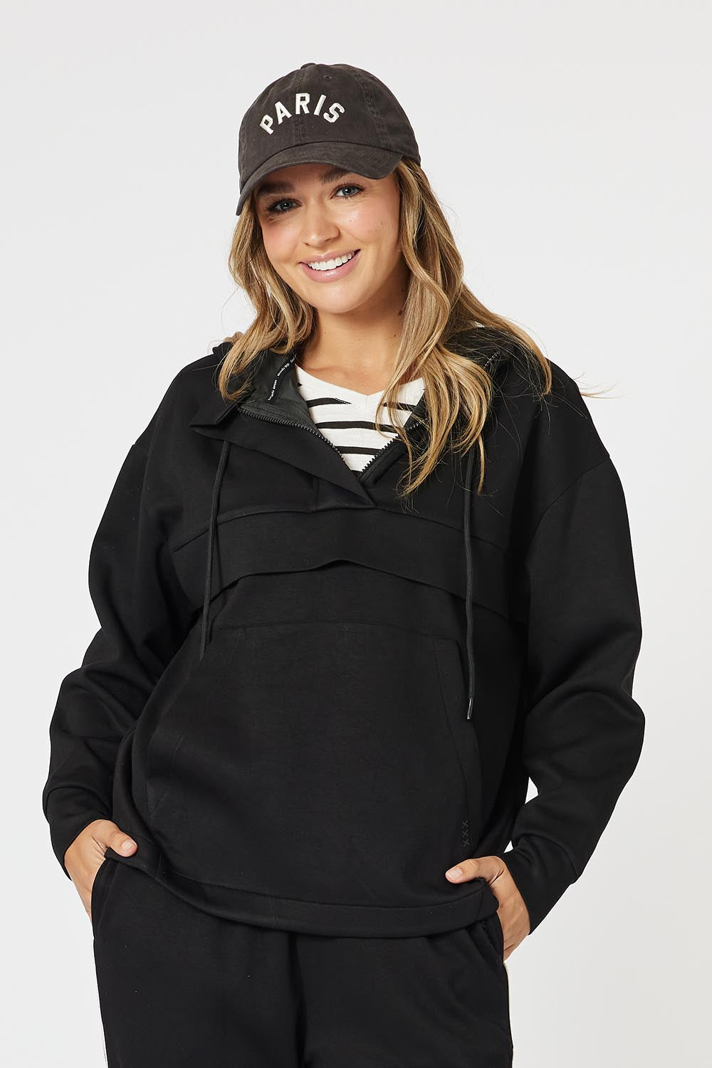 A model wearing the Evie Sweatshirt in colour Black (Black), from the front, cropped image