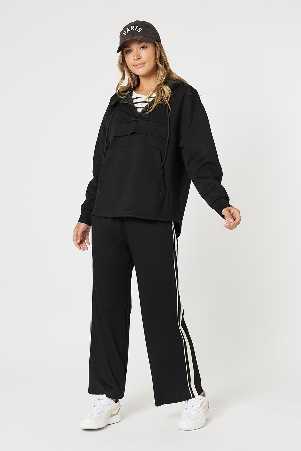 A model wearing the Evie Sweatshirt in colour Black (Black), from the front, showing the whole outfit