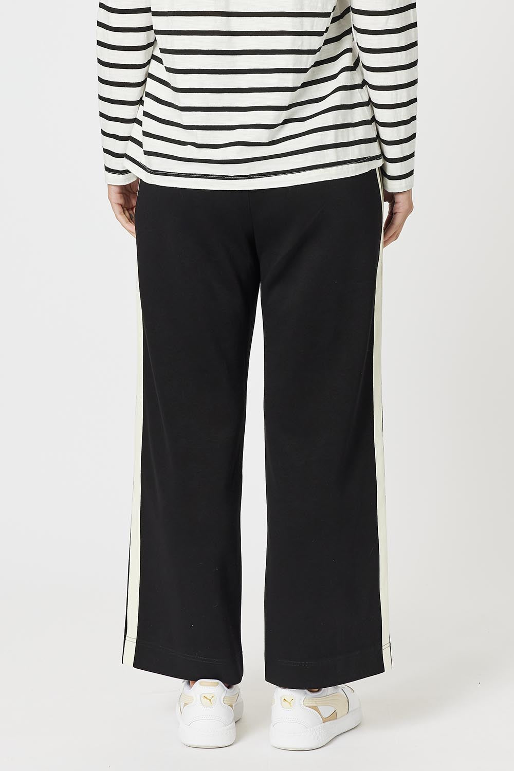 A model wearing the Urban Pant in colour Black (Black), from the back