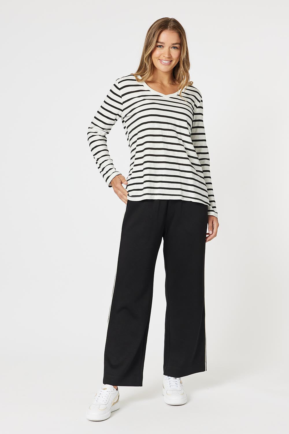 A model wearing the Urban Pant in colour Black (Black), from the front, showing the whole outfit