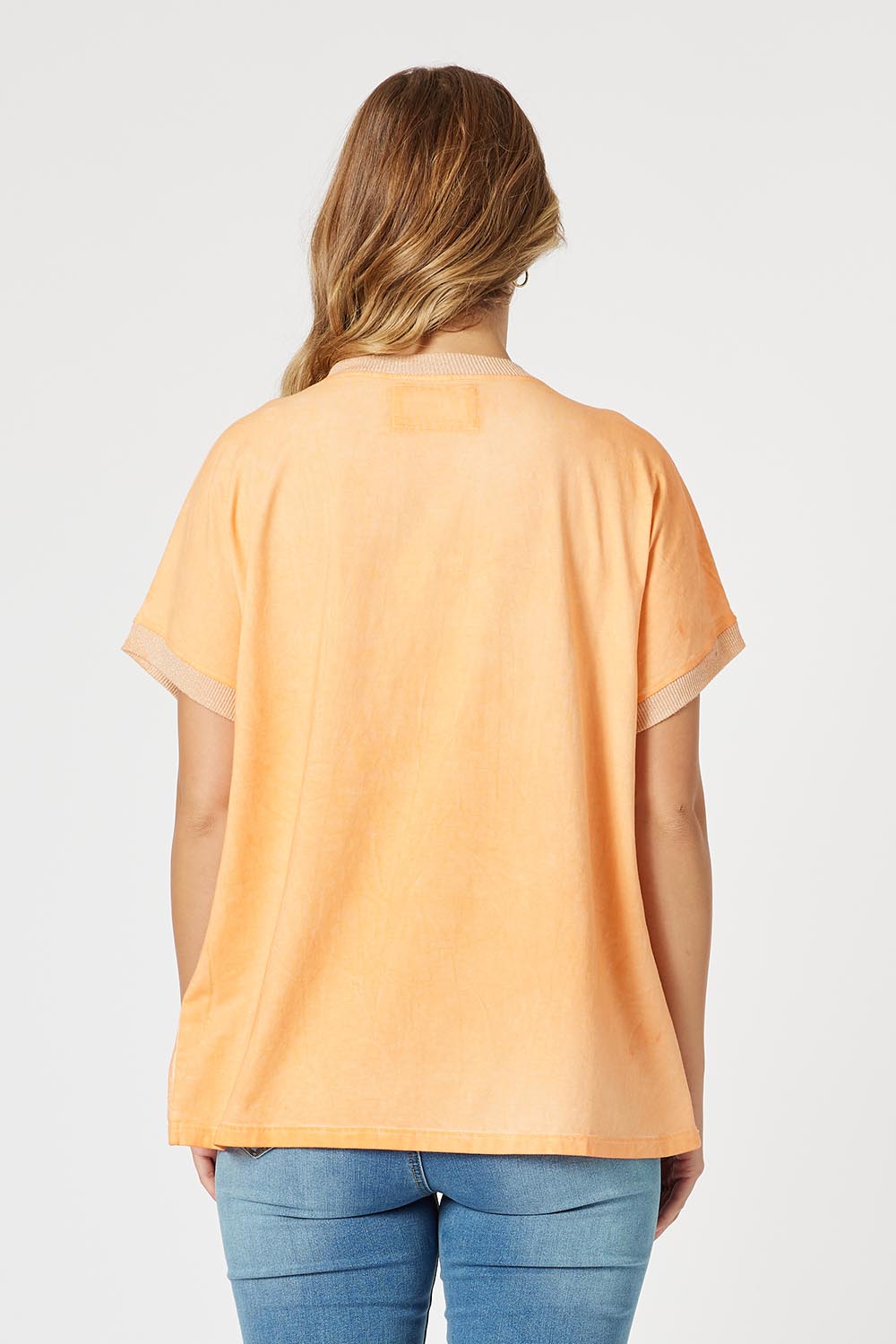 A model wearing The Sienna Linen Blend Tee in colour Orange, from the back