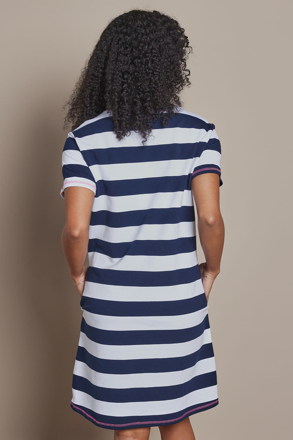 Model Ziara wearing size S of the Love & Kisses Cotton Dress in colour Navypink (Blue), from the back