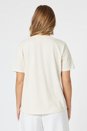 A model wearing the Dolce Vita Cotton Blend Tee in colour Natural, from the back