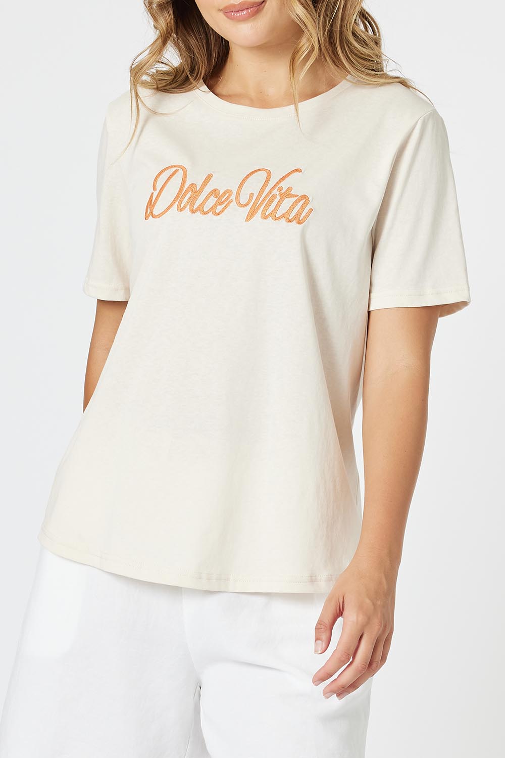 A model wearing the Dolce Vita Cotton Blend Tee in colour Natural, from the front, cropped image