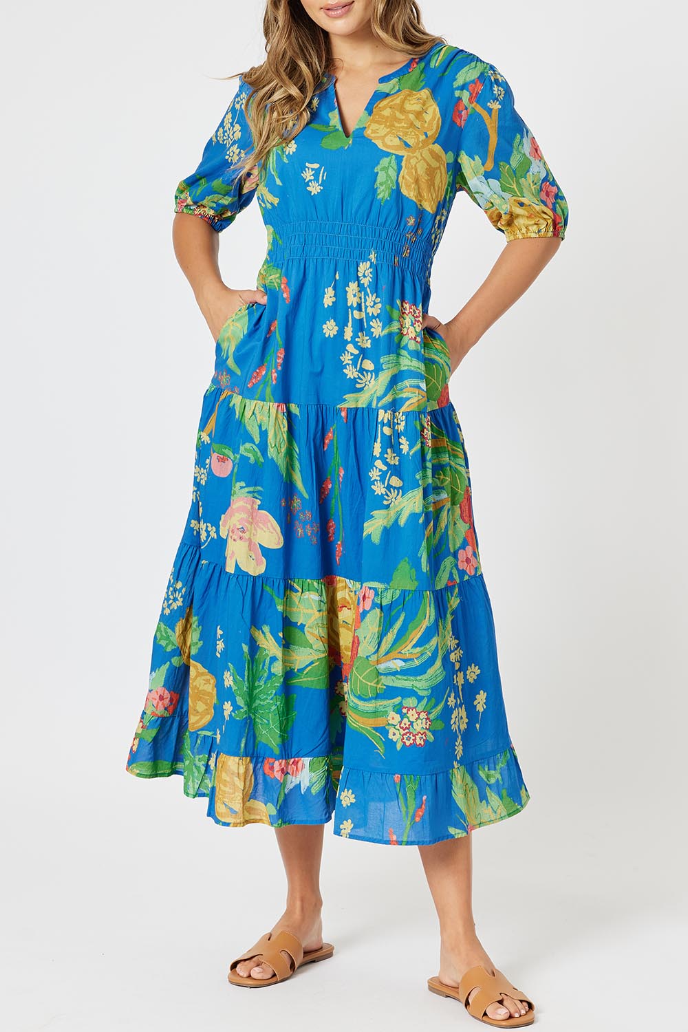 A model wearing the Tropics Cotton Dress in colour Blue (Blue), from the front, cropped image