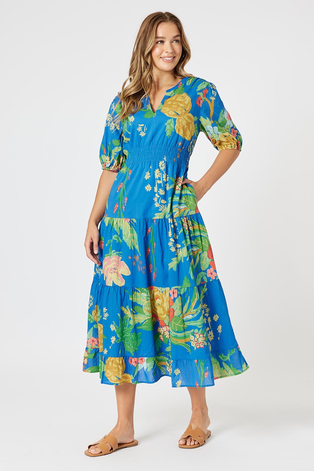A model wearing the Tropics Cotton Dress in colour Blue (Blue), from the front, showing the whole outfit