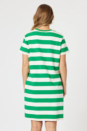 A model wearing the Heart Stripe Cotton Dress in colour Elmwhite (Green), from the back