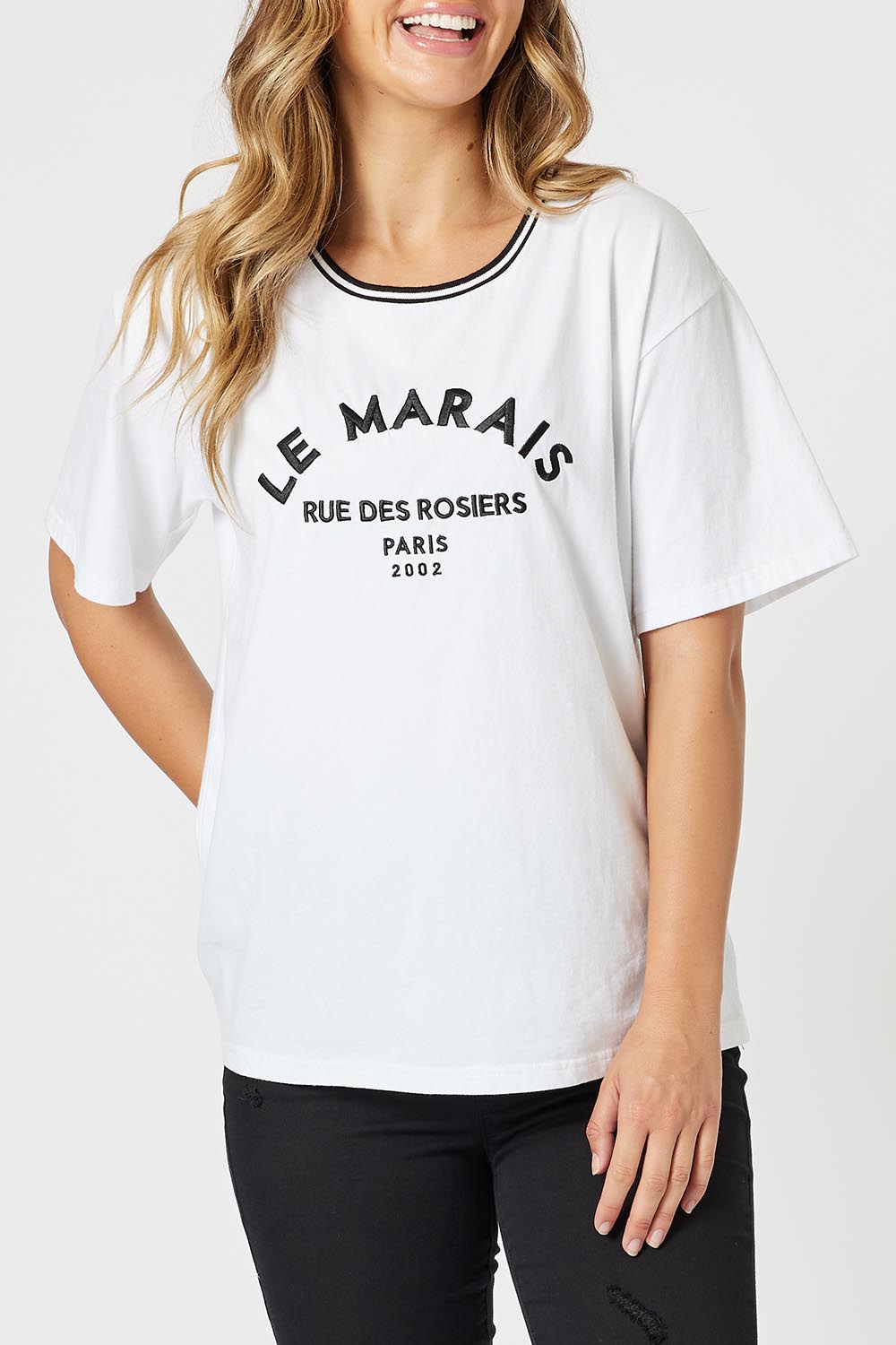 A model wearing the Le Marais Cotton Tee in colour White (White), from the front, cropped image