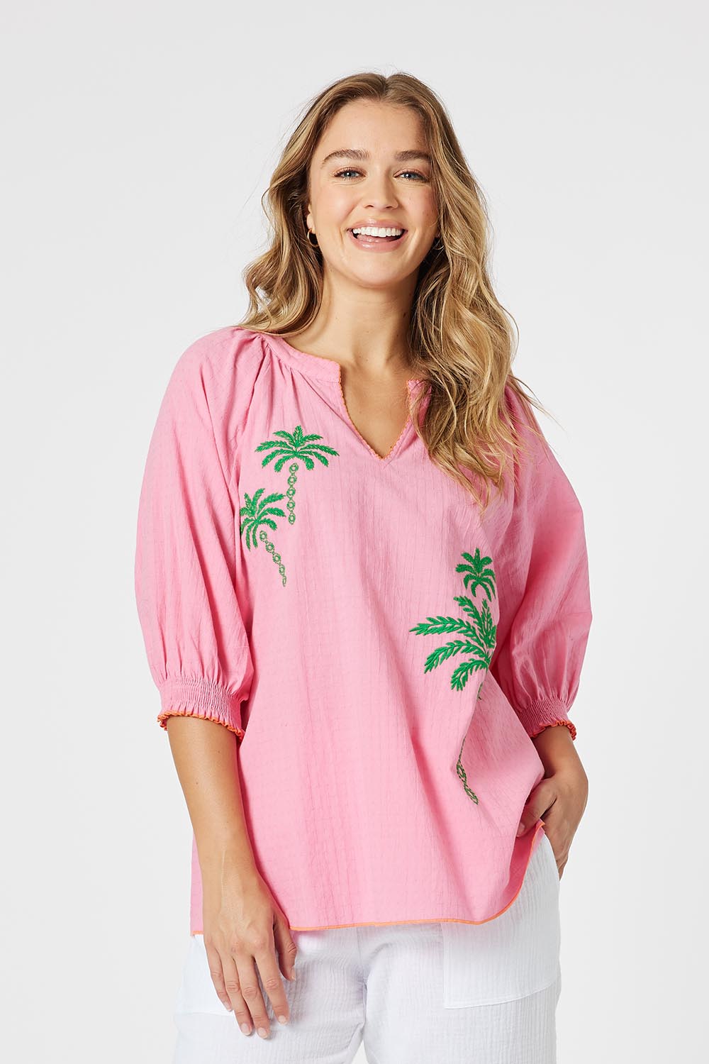 A model wearing the Pina Colada Embroidered Cotton Top in colour Pink (Pink), from the front, cropped image